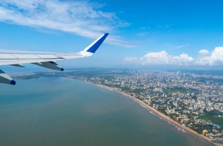 Airplane above Mumbai and sea