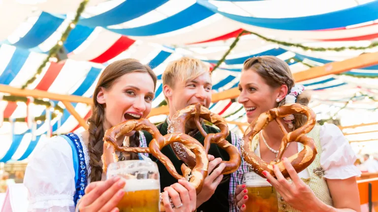 Friends eating pretzels at Oktoberfest, Munich