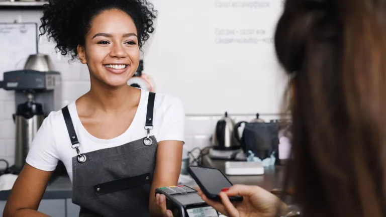 Woman paying at cafe