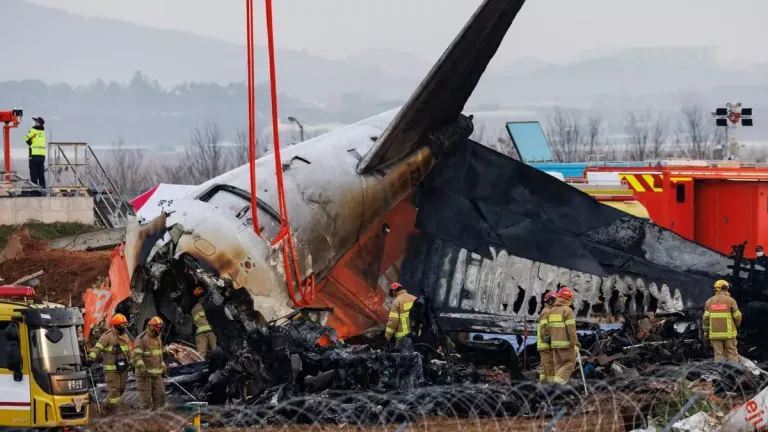 Firefighters inspect the wreckage of Jeju Air Co. Flight 2216