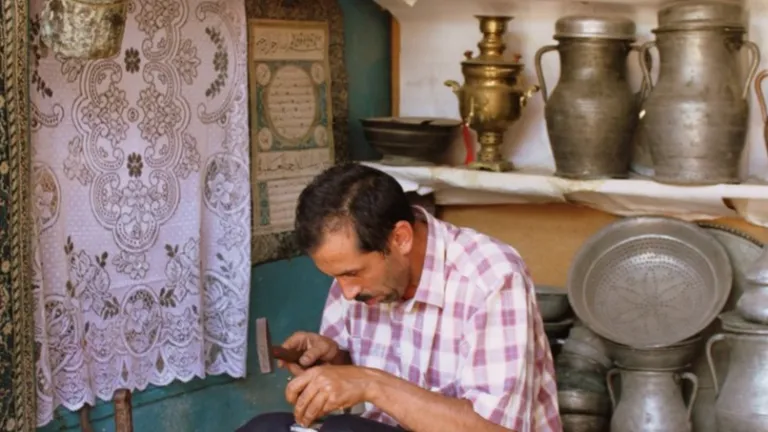 Lahij craftsman working on copperware