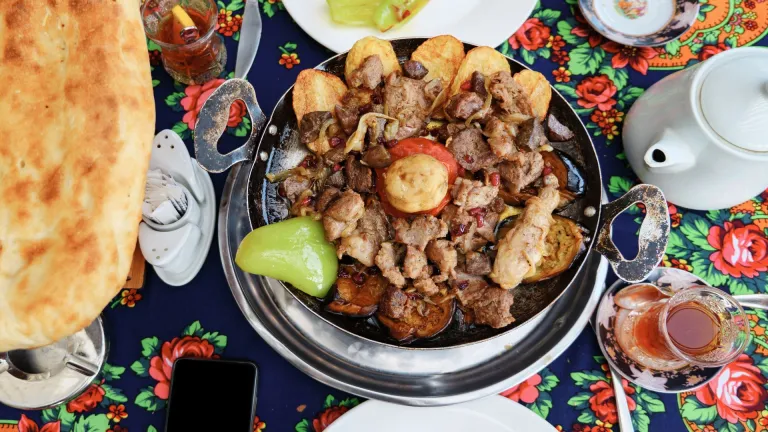 Traditional Azerbaijani platter with grilled meat and tea