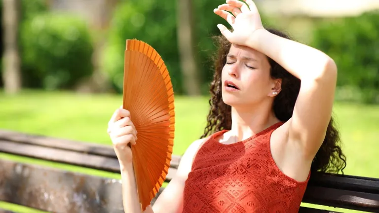 Woman in a park suffering heat stroke