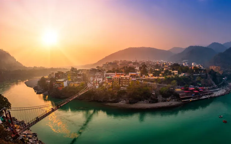 Golden sunset light falling over the Ganges in Rishikesh.