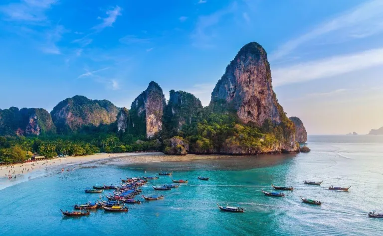 Turquoise water and towering limestone cliffs at Railay Beach, Thailand.