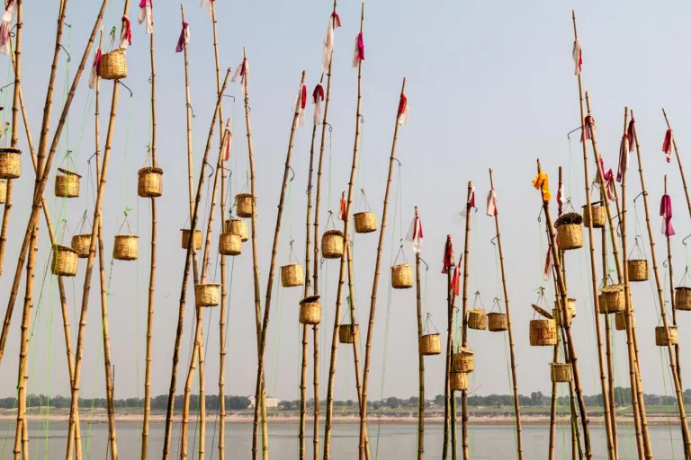 Lamps in baskets on bamboo poles in Varanasi, Ind