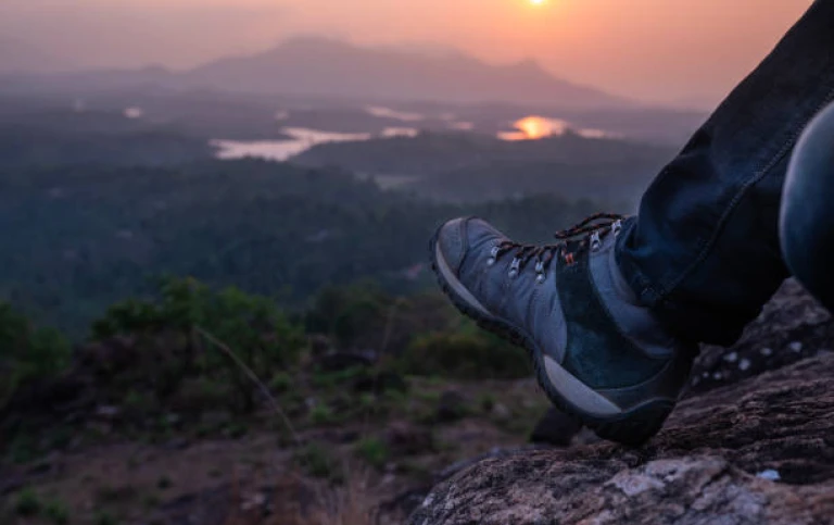 Solo traveler reminiscing about his travel with a sunset view