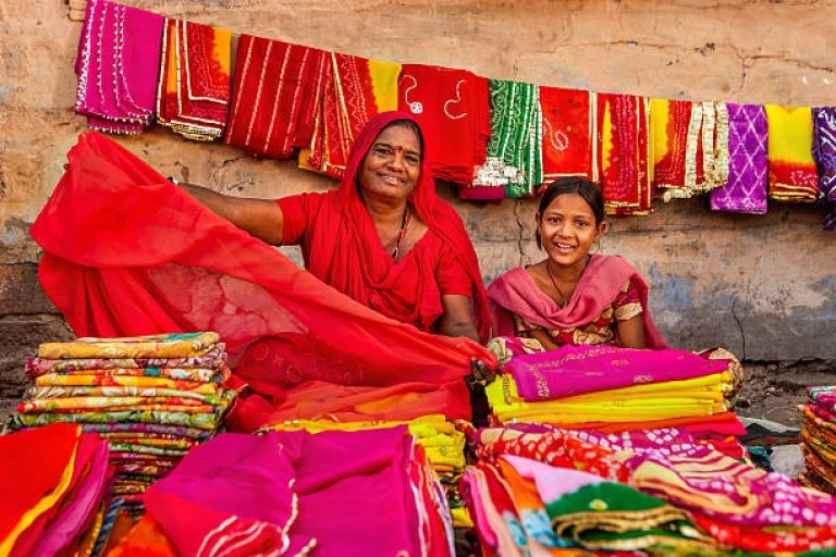 Indian women selling colorful fabrics