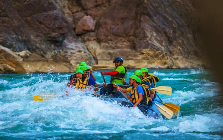 Young people enjoyinh whitewater river rafting in River ganges