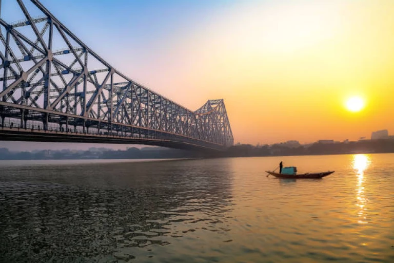 Historic Howrah bridge with boat on river Ganges at Kolkata, India