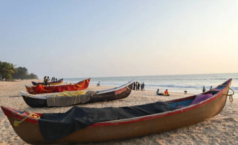 A Dramatic Twilight picture of the Padubidri, one of the Blue Flag Beach destinations in the world seen with the Fishing boats Stationed on the Sands in India.