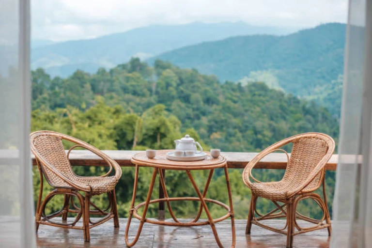 Teapot set on table in the morning with mountain view at countryside home or homestay.